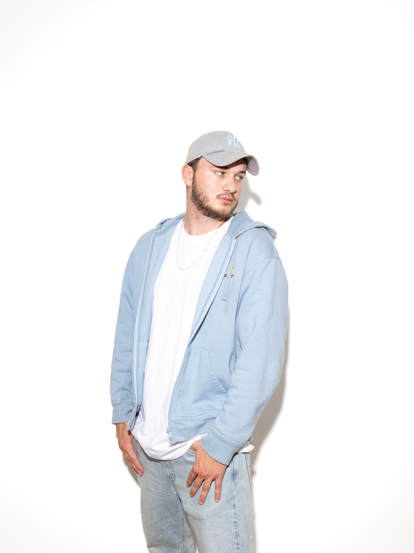 :DARREN studio portrait in light blue hoodie and cap